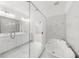 Bright bathroom featuring double vanity, soaking tub, marble floors, and modern glass enclosed shower at 205 Carrington Pt, Canton, GA 30115
