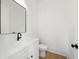 Modern half bathroom featuring a black faucet, mirror, and cabinet pulls against bright white walls at 205 Carrington Pt, Canton, GA 30115