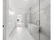 Bright bathroom featuring double vanity, soaking tub, marble floors, and modern glass enclosed shower at 205 Carrington Pt, Canton, GA 30115