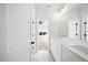 Bathroom features a white double vanity, marble floor, and open doorway to another room at 205 Carrington Pt, Canton, GA 30115
