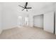 Spacious bedroom featuring neutral carpet, ceiling fan, and access to ensuite bathroom and closet at 205 Carrington Pt, Canton, GA 30115