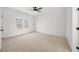 Neutral bedroom with large window, plush carpet, and white walls at 205 Carrington Pt, Canton, GA 30115