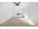 Bedroom featuring neutral carpet, ceiling fan, and view to outside at 205 Carrington Pt, Canton, GA 30115