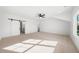 Large bedroom with window and barn door access to the primary bath at 205 Carrington Pt, Canton, GA 30115