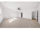 Spacious bedroom with large window and sliding barn door access to the bath at 205 Carrington Pt, Canton, GA 30115
