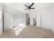 Bright bedroom features plush carpet, ceiling fan, and closet at 205 Carrington Pt, Canton, GA 30115