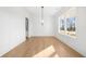 Inviting dining room with hardwood floors, paneled walls, a modern chandelier, and ample natural light at 205 Carrington Pt, Canton, GA 30115