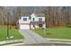 Beautiful two-story home showcasing a well-maintained lawn and an extended driveway at 205 Carrington Pt, Canton, GA 30115