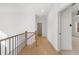 Bright hallway with beautiful wood floors and natural light leading to an open door on the right at 205 Carrington Pt, Canton, GA 30115