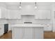 Spacious kitchen with a large center island, white cabinets, and modern pendant lights at 205 Carrington Pt, Canton, GA 30115
