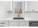 Kitchen detail showcasing quartz countertops, stainless steel sink and modern cabinetry at 205 Carrington Pt, Canton, GA 30115
