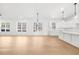 Modern, open-concept kitchen with white cabinets, hardwood floors and stainless steel appliances at 205 Carrington Pt, Canton, GA 30115
