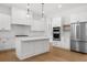 Modern kitchen features stainless steel appliances, center island, and stylish pendant lighting at 205 Carrington Pt, Canton, GA 30115