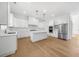 New kitchen with white cabinets, stainless steel appliances, island, and hardwood floors at 205 Carrington Pt, Canton, GA 30115