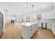 Well-lit kitchen with a large island, stainless steel appliances, and open access to living area at 205 Carrington Pt, Canton, GA 30115