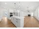 Bright, open kitchen featuring a large island, pendant lights, and stainless steel appliances at 205 Carrington Pt, Canton, GA 30115
