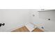 This laundry room has light hardwood floors and white walls at 205 Carrington Pt, Canton, GA 30115
