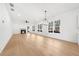 Bright, open living room with a fireplace, modern lighting, and large windows at 205 Carrington Pt, Canton, GA 30115