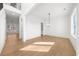 Spacious living room featuring hardwood floors, large windows, and modern lighting fixtures at 205 Carrington Pt, Canton, GA 30115