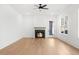 Living room with a fireplace, ceiling fan, large windows, and a glass door to the exterior at 205 Carrington Pt, Canton, GA 30115