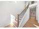 Elegant staircase with wooden treads and sleek black railings, bathed in natural light at 205 Carrington Pt, Canton, GA 30115