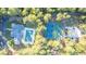 Aerial view of the property featuring a pool, sports courts, and lush green landscaping at 2191 Lakeview Pkwy, Villa Rica, GA 30180