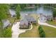 Aerial view of house with a long driveway, manicured lawn, and lake access at 2191 Lakeview Pkwy, Villa Rica, GA 30180