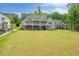 Exterior view of this home showing the green backyard and the large outdoor deck at 2191 Lakeview Pkwy, Villa Rica, GA 30180