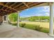 Covered patio overlooking lush green lawn, waterfront views and mature trees at 2191 Lakeview Pkwy, Villa Rica, GA 30180
