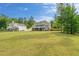A large backyard features a spacious lawn and home with an outdoor deck at 2191 Lakeview Pkwy, Villa Rica, GA 30180
