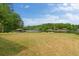 Lush backyard with mature trees and lake access, highlighting the home's outdoor appeal at 2191 Lakeview Pkwy, Villa Rica, GA 30180
