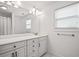 Bathroom featuring a double vanity with marble countertop and modern fixtures and lots of natural light at 2191 Lakeview Pkwy, Villa Rica, GA 30180