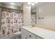 Stylish bathroom featuring a unique shower curtain, marble countertop, and a large mirror at 2191 Lakeview Pkwy, Villa Rica, GA 30180