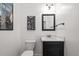 Half bathroom featuring a black vanity and framed automotive themed wall art at 2191 Lakeview Pkwy, Villa Rica, GA 30180