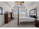 Cozy primary bedroom with wood furniture, neutral carpet, and a window with wooded views at 2191 Lakeview Pkwy, Villa Rica, GA 30180