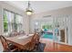 Bright dining area features wood floors, chandelier, and view of adjacent sunroom and backyard at 2191 Lakeview Pkwy, Villa Rica, GA 30180