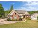 Charming brick and siding home with lush lawn and manicured landscaping and convenient side-entry garage at 2191 Lakeview Pkwy, Villa Rica, GA 30180