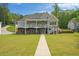 Home exterior featuring a manicured lawn and expansive deck with lake views at 2191 Lakeview Pkwy, Villa Rica, GA 30180