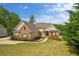 Beautiful house with attached garage, long driveway and well-manicured lawn overlooking a tranquil lake at 2191 Lakeview Pkwy, Villa Rica, GA 30180