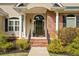 Welcoming front entrance with brick steps and columns and manicured landscaping at 2191 Lakeview Pkwy, Villa Rica, GA 30180