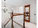 Hallway with decorative mirror and a charming chandelier at the top of the carpeted stairs at 2191 Lakeview Pkwy, Villa Rica, GA 30180