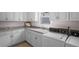 Laundry room features white cabinets, granite counters, a sink, and modern washer and dryer at 2191 Lakeview Pkwy, Villa Rica, GA 30180