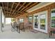 Covered patio space featuring a dining set with brick accents and double glass doors at 2191 Lakeview Pkwy, Villa Rica, GA 30180