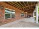 Covered brick patio with exposed wood beams and outdoor seating and dining space at 2191 Lakeview Pkwy, Villa Rica, GA 30180
