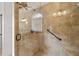 Tiled shower featuring a glass door, rainfall shower head and grab bar at 2191 Lakeview Pkwy, Villa Rica, GA 30180
