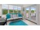 Sunroom overlooking the lake features neutral seating with bright cushions and an outdoor access at 2191 Lakeview Pkwy, Villa Rica, GA 30180