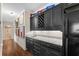 Wet bar with dark cabinets and granite countertops at 2191 Lakeview Pkwy, Villa Rica, GA 30180