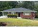 Charming brick home with a well-maintained lawn and covered parking at 2833 Oldknow Nw Dr, Atlanta, GA 30318