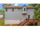 Back exterior view of a two-story home with a red deck and yard at 31 Fairview Oak Cv, Dallas, GA 30157