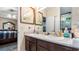 Bright bathroom with double sinks, wood cabinets, and access to the main bedroom at 31 Fairview Oak Cv, Dallas, GA 30157